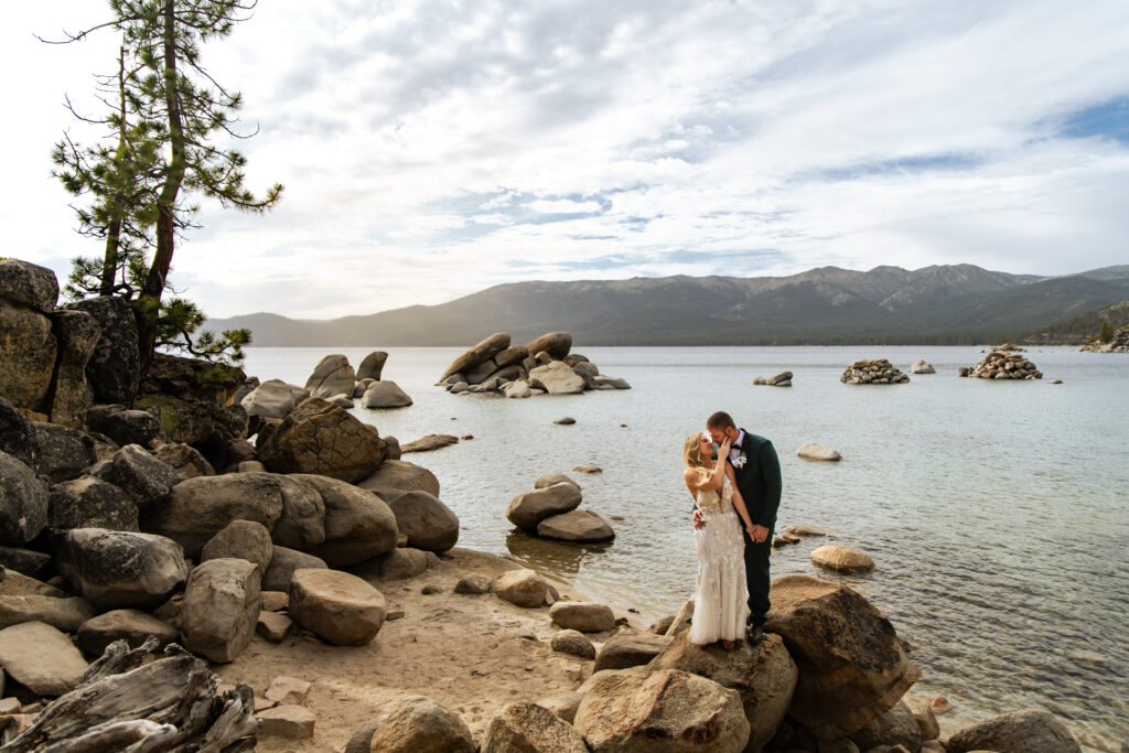 stunning couple looking at each other  with lake tahoe in the background