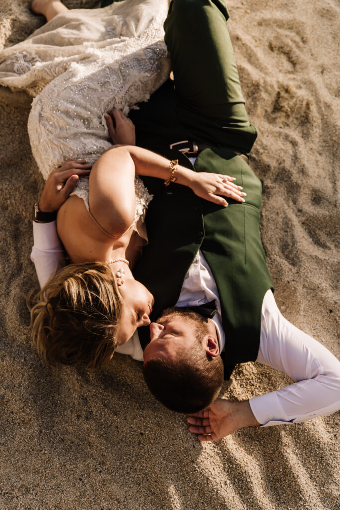 couple lying down on the sand