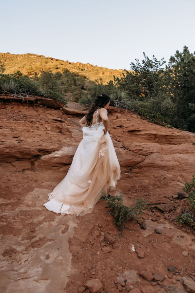 bride walking on the mountain during her elopement