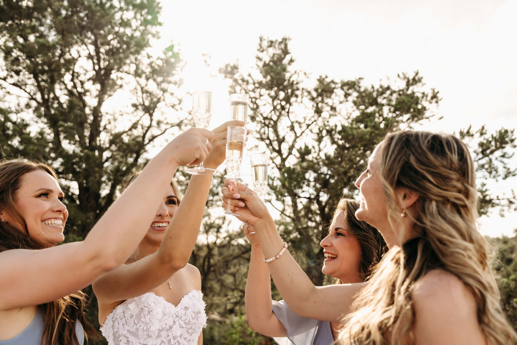 bride and bridesmaids drinking champagne 