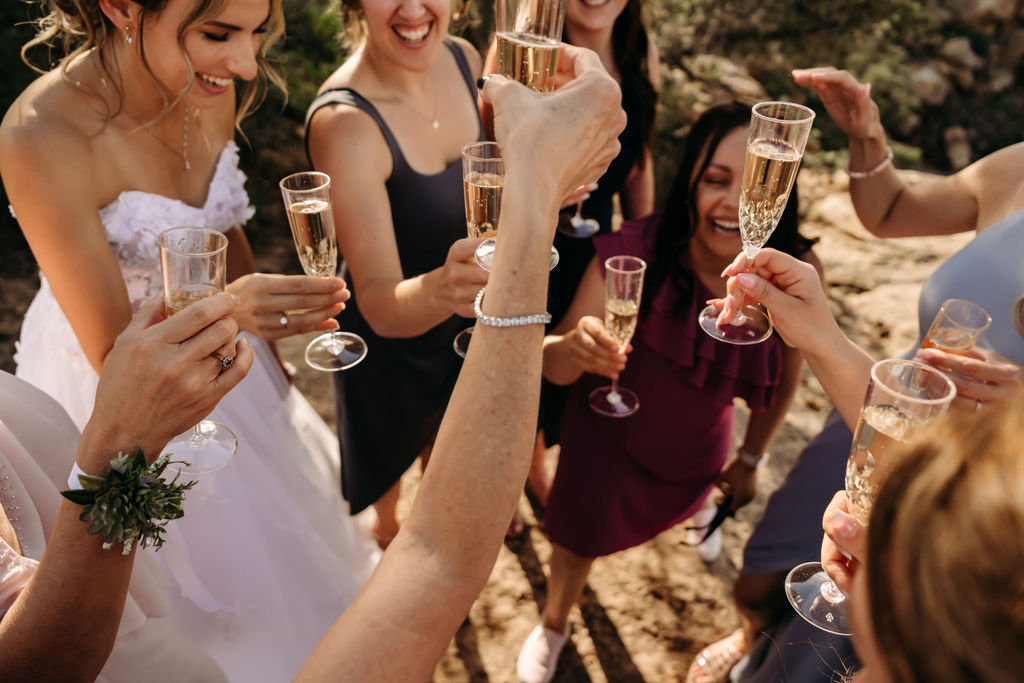 bride and guests drinking champagne at her intimate mountain elopement