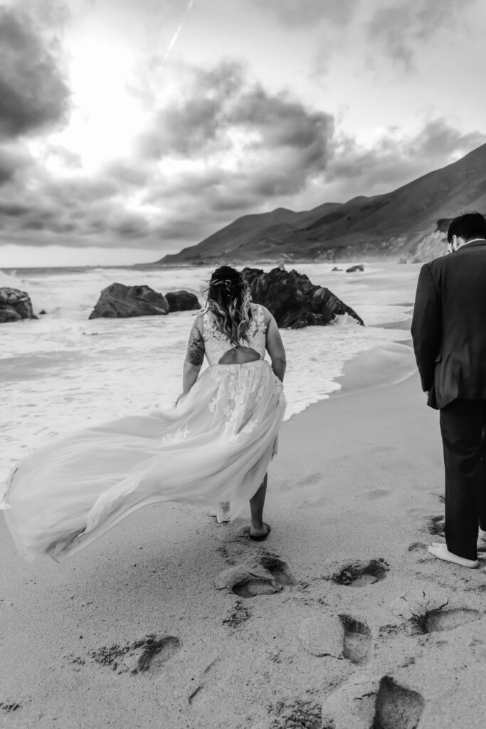 couple walking in the beach during their vow renewal elopement