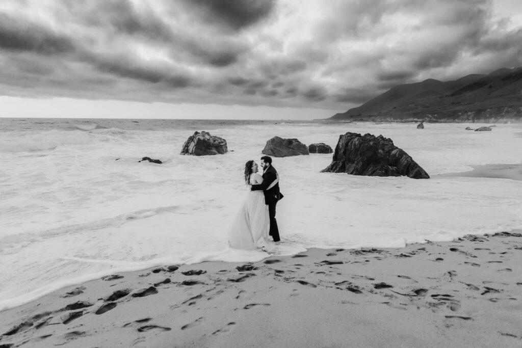 couple at the big sur coastline at their vow renewal elopement