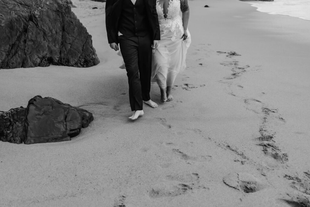 eloped couple walking on the coastline 