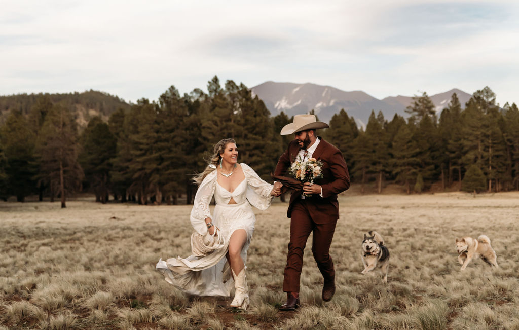 cute couple holding hands running during their photoshoot - elope in arizona